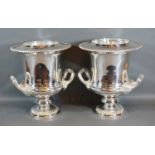 A Pair of Silver Plated Two Handled Wine Coolers with inner liners upon circular pedestal bases 27cm