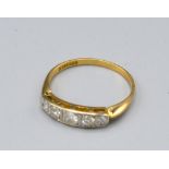 An 18ct. Gold Five Stone Diamond Ring set with five graduated diamonds within a pierced setting,