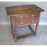 A George III Oak Low Boy, the plank top above two drawers with brass drop handles raised upon turned