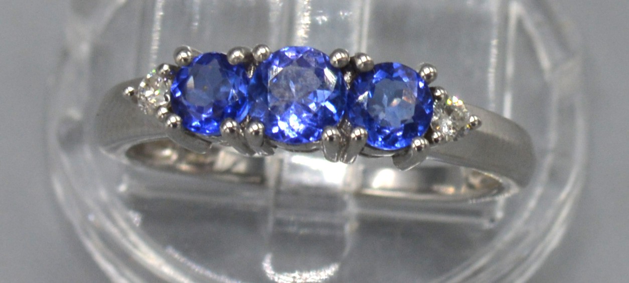 An 18ct. White Gold Tanzanite and Diamond Ring set with three tanzanite flanked by small diamonds, - Image 2 of 2