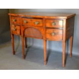 A George IV Mahogany Bow Fronted Sideboard with an arrangement of drawers and cupboard with brass