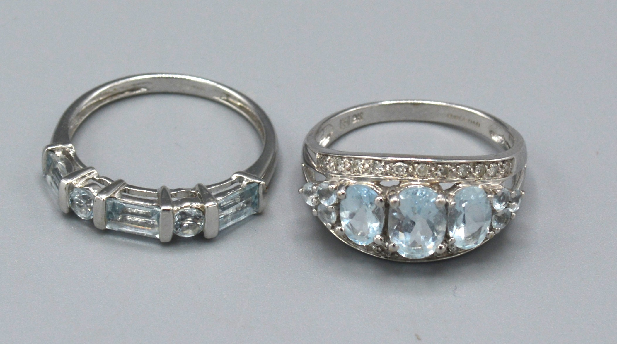 A 9ct. White Gold Aquamarine and Diamond Set Dress Ring, ring size O, 2.9 gms. together with another