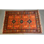 A North West Persian Woollen Rug with an all over design upon a red blue and cream ground within