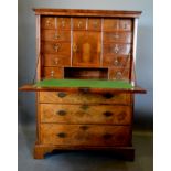 A Walnut Escritoire, the moulded cornice above a fall front enclosing a fitted interior with drawers