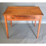 A 19th Century Oak Side Table the frieze drawer with brass handles raised upon square tapering legs,