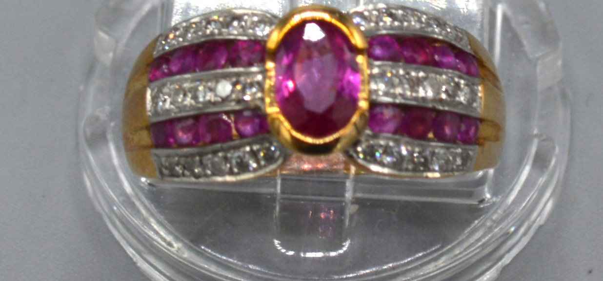 A 9ct. Gold Ruby and Diamond Ring with central oval ruby flanked by bands of rubies and diamonds, - Image 2 of 2