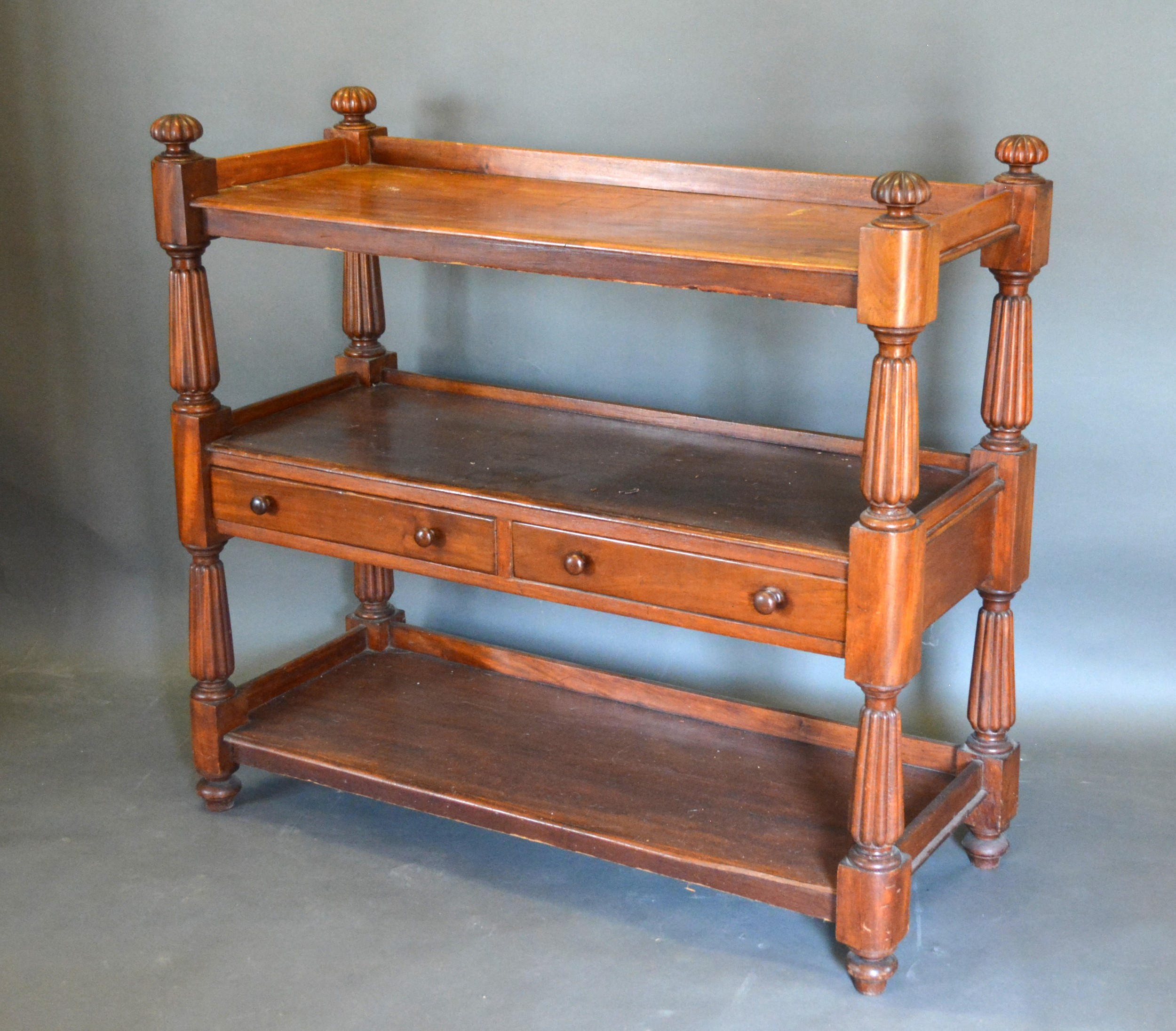 A Victorian Mahogany Buffet, the low galleried top above two central drawers with knob handles