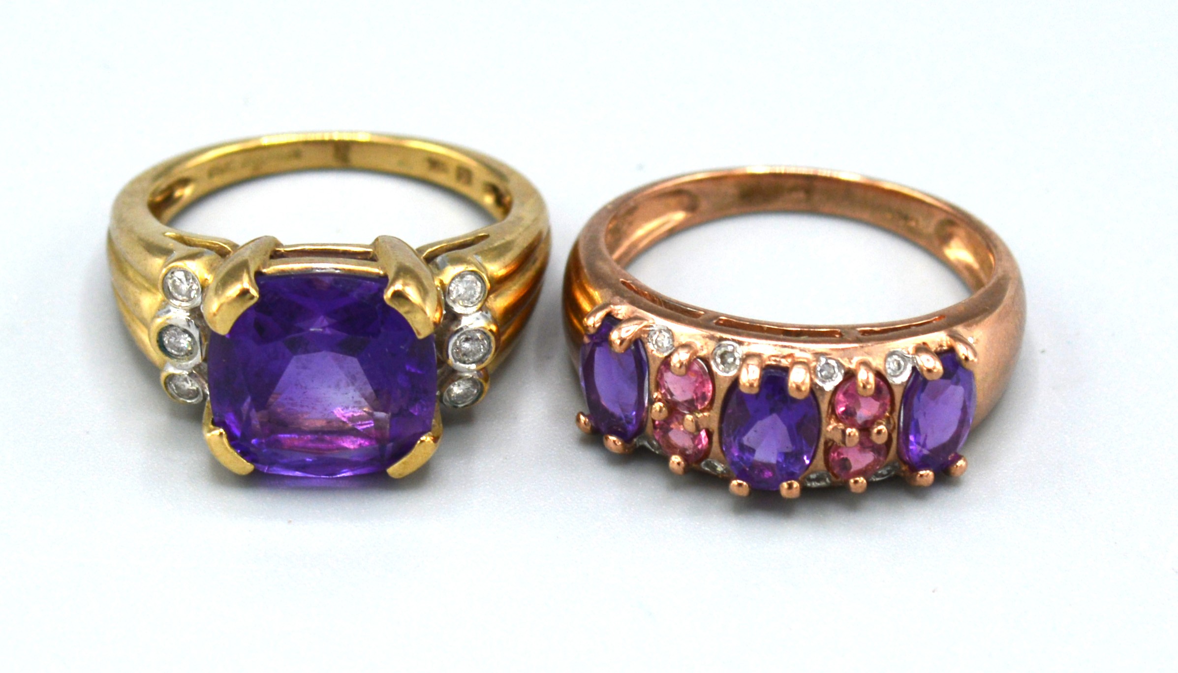A 9ct. Gold Dress Ring with central amethyst flanked by diamonds, ring size K, 4.7 gms. together