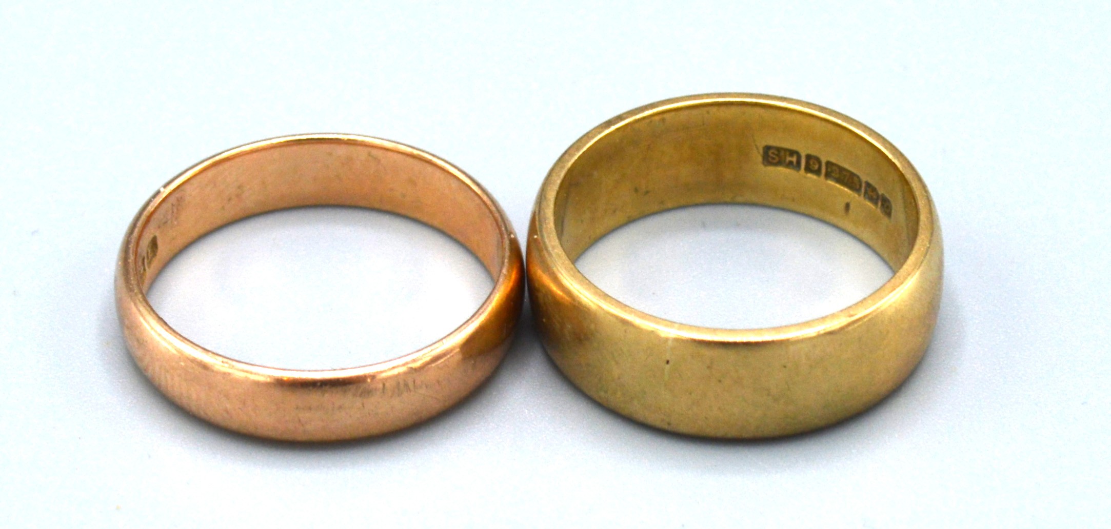 A 9ct. Gold Wedding Band together with another similar 9ct. gold wedding band, 7.2 gms.