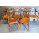 A Set of Six 19th Century Mahogany Dining Chairs each with a carved rail back with roundel above a