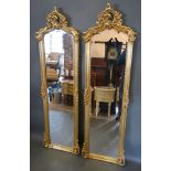 A Pair of French Gilded Dressing Mirrors of pierced scroll form, 53 cms wide, 177.5 cms tall