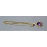 A 9ct. Gold Amethyst Set Pendant of oval pierced form together with a 9ct. gold linked chain, 6.1