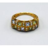 A 9ct. Gold Band Ring set peridot, aquamarine and small diamonds interspaced, ring size N, 3.8 gms.