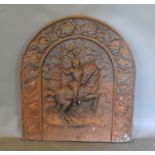An early cast iron fire back of arched form, decorated in relief with a figure on horse back,