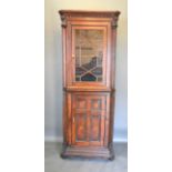 A 19th Century Oak Standing Corner Cabinet, the moulded top above an astragal glazed door
