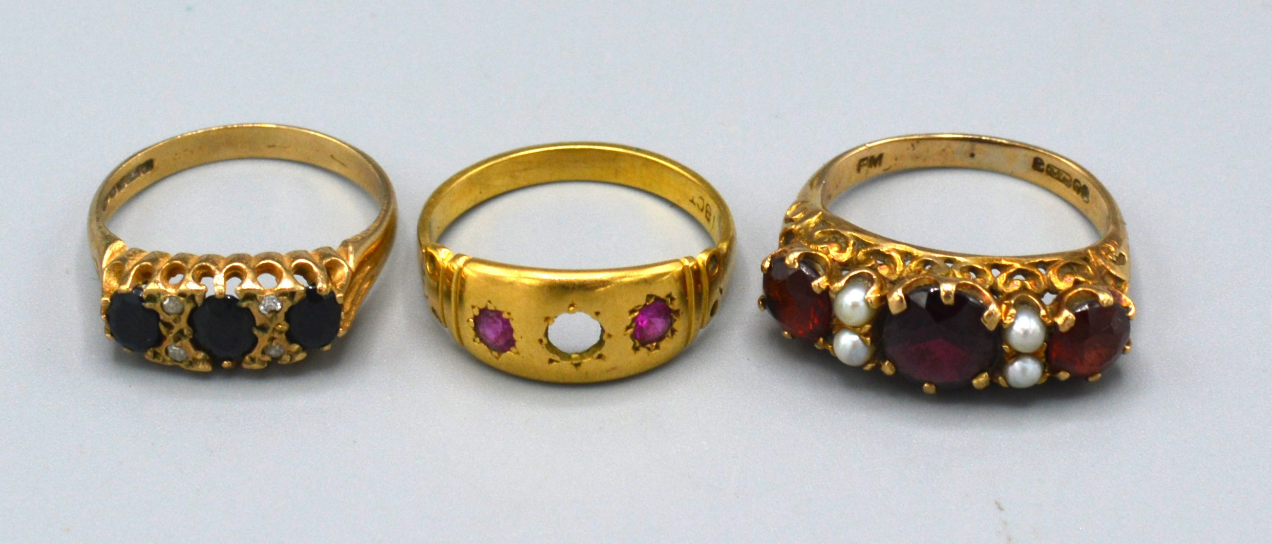 A 9ct. Gold Dress Ring set three garnets interspaced with pearls, ring size M, 3.4 gms. together