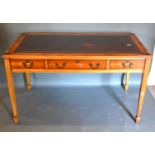 A 20th Century Writing Desk, the red tooled leather inset top above three frieze drawers with