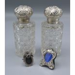 A Pair of Silver Topped Cut Glass Scent Bottles, 13.5 cms tall together with two miniature silver