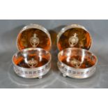 A Set of Four Silver Plated and Simulated Tortoiseshell Bottle Coasters, 12.5 cms diameter