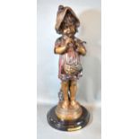 A Patinated Bronze Model in the form of a girl holding a bird bearing signature Fuenze and with