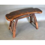 A Chinese Hardwood Bench of shaped form with shaped end supports, 83.5 cms long, 26 cms deep, 51 cms