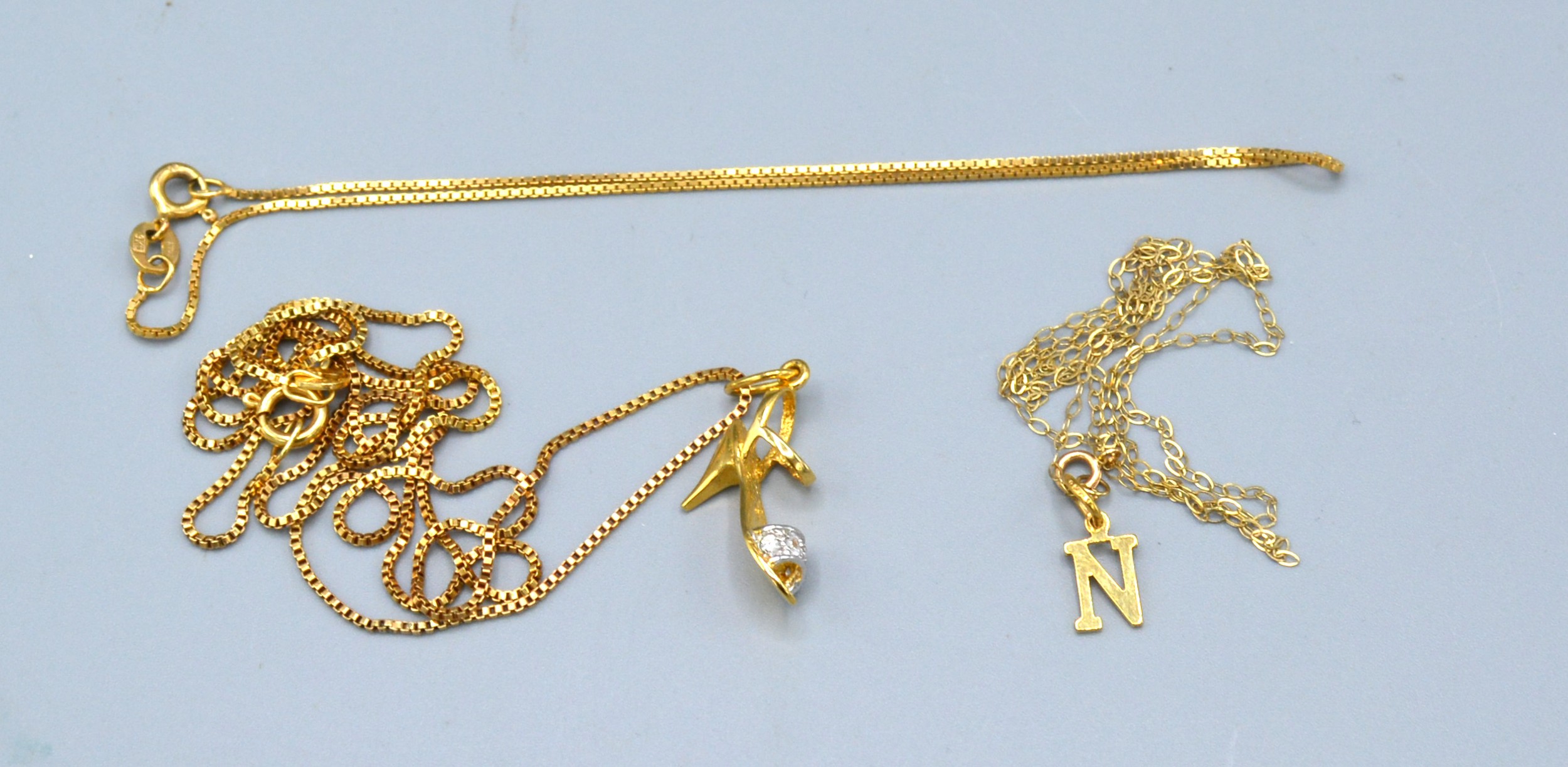 A 9ct. Gold Pendant in the form of a Shoe together with a 9ct. gold neck chain, 3.9 gms. together