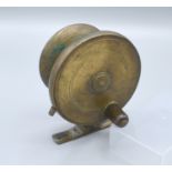 A Mallochs Patent side casting fishing reel, 10cms diameter