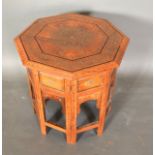 An Indian Hardwood Octagonal Small Table, the brass inlaid top above similar supports, 43 cms
