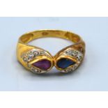 An 18ct. Gold Ring set teardrop sapphire and ruby surrounded by diamonds, ring size O, 3.2 gms.