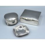 A Chester Silver Cigarette Box together with a Birmingham silver ashtray and a Birmingham silver