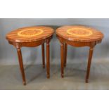A Pair of French marquetry inlaid oval lamp tables each with an oval marquetry inlaid moulded top