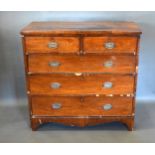 A 19th century mahogany straight front chest of two short and three long drawers with oval brass