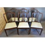 A Set of Six Late 19th Early 20th Century Hepplewhite Style Dining Chairs each with a shaped pierced