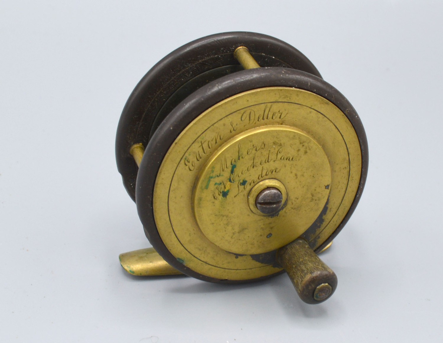 Eaton and Deller a brass mounted fishing reel, 6.5cms diameter