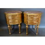 A Pair of French Gilded Oval Chests, the variegated marble tops above three drawers raised upon