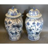 A Pair of Chinese Underglaze Blue Large Covered Vases, the covers with dogs of fo surmount, 55 cms