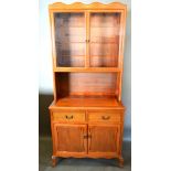 A Chinese Hardwood Dresser with two glazed doors enclosing glass shelves, the lower section with two