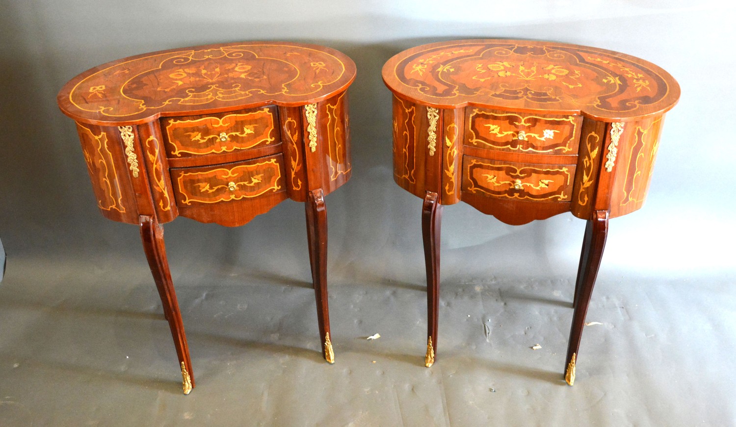A pair of French style Marquetry inlaid and gilt metal mounted kidney shaped side tables, each