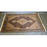 A North West Persian Silk Rug with a central medallion within an all over design upon a blue and