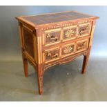 A French inlaid two drawer bedroom chest, the inlaid top above two similar drawers with brass