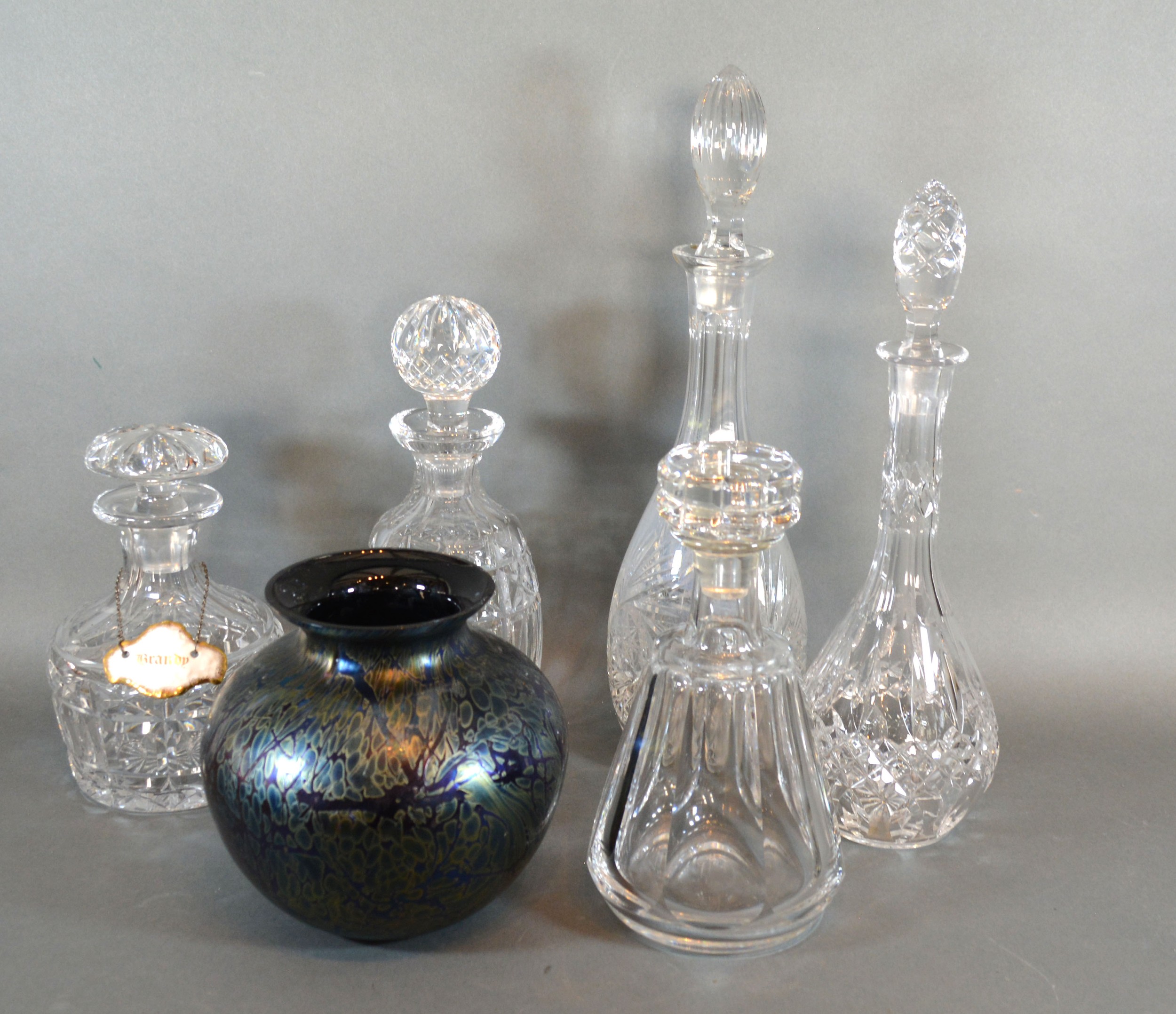 A Baccarat Glass Decanter with stopper together with four other similar decanters and an Isle of