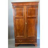 A late 19th century mahogany hall cupboard, the moulded cornice above two doors above drawer