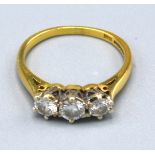 An 18ct. Gold Three Stone Diamond Ring, the three diamonds claw set, approx. 0.50 ct. total