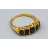 An 18ct. Gold Sapphire and Diamond Ring set with five graduated sapphires interspaced with small