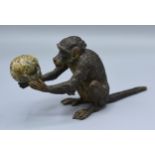 A Late 19th/Early 20th Century Patinated Bronze Model in the form of a Monkey holding a Skull, 14
