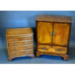 A 20th Century Small Chest with a brushing slide above two short and three long drawers with brass