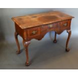 A 19th Century Queen Anne Style Walnut Low Boy, the cross banded and moulded top above three drawers