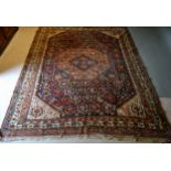 A North West Persian Woollen Large Rug with a central medallion within an all over design upon a red