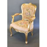 A French Gilded Armchair with a tapestry upholstered back and seat raised upon cabriole legs with