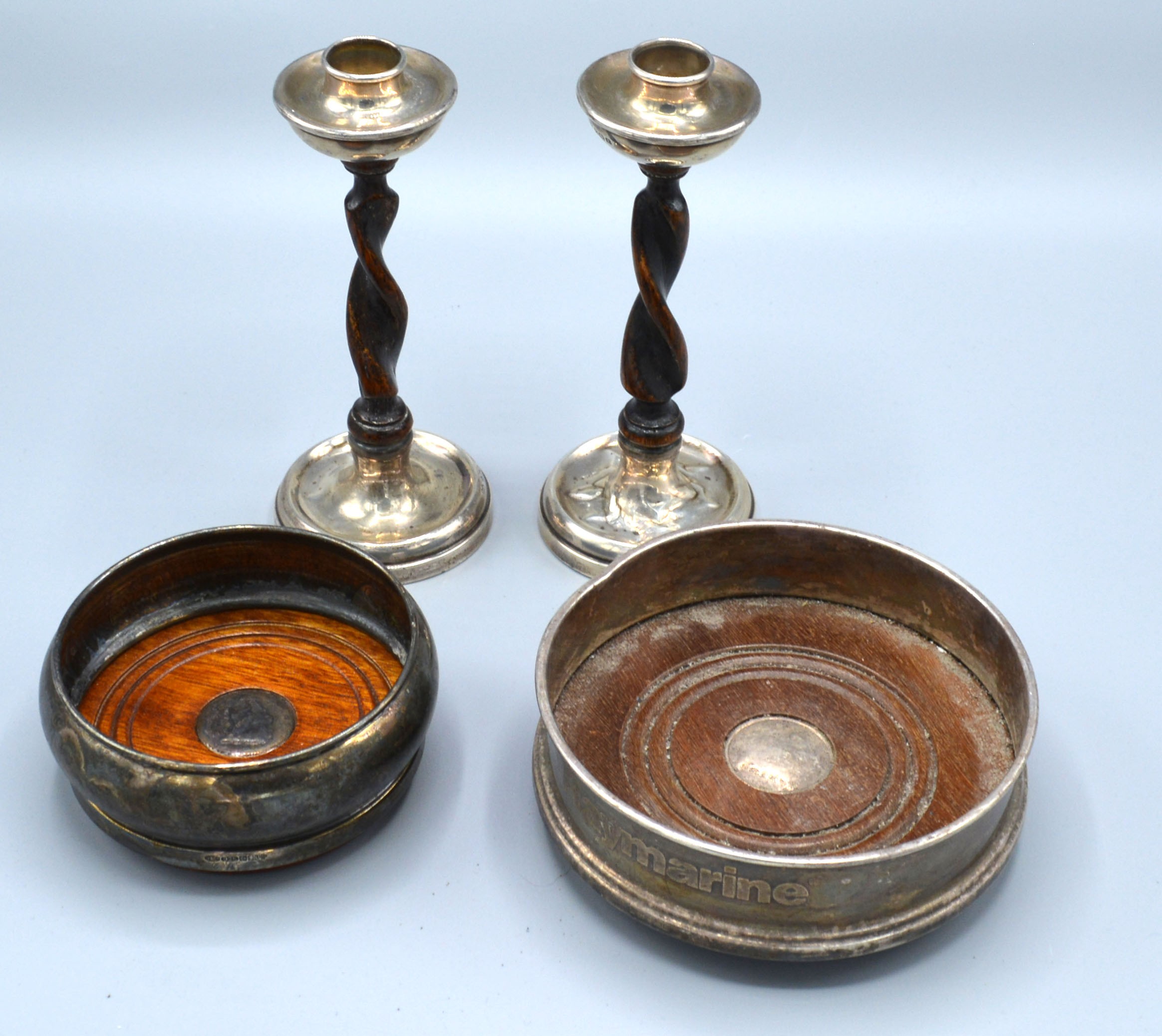 A Pair of Birmingham Silver Mounted Candlesticks together with two 925 silver bottle coasters